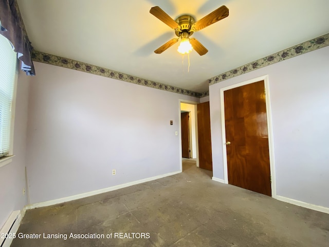 unfurnished bedroom with baseboard heating, a closet, a ceiling fan, and baseboards