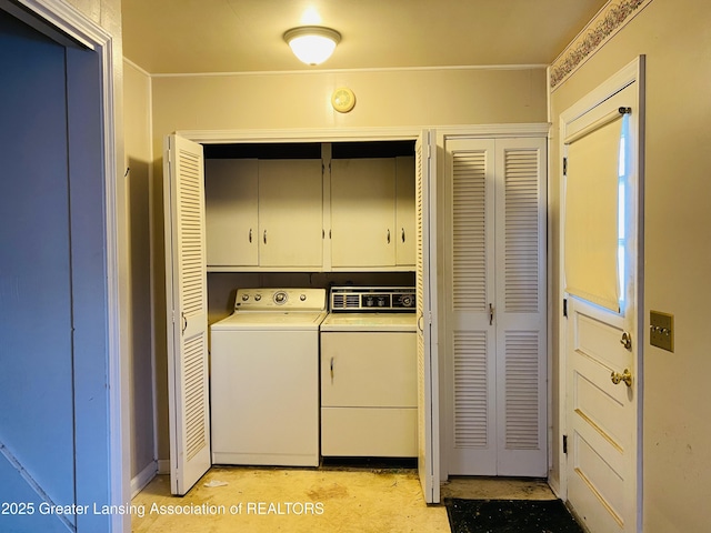 laundry room featuring independent washer and dryer and cabinet space