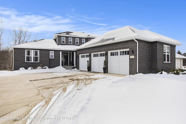 view of front of house with a garage and brick siding