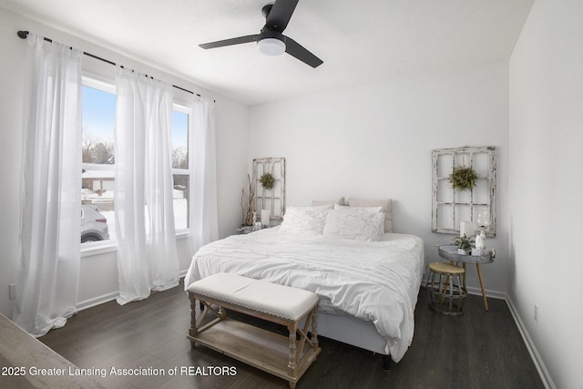 bedroom with a ceiling fan, baseboards, and wood finished floors