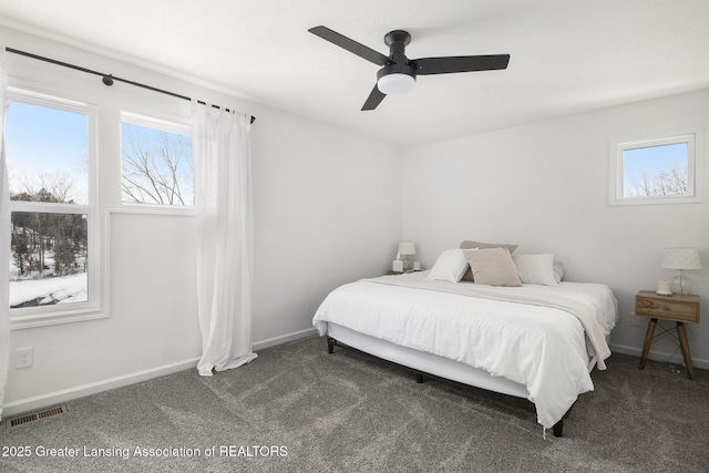 carpeted bedroom featuring baseboards, visible vents, and ceiling fan