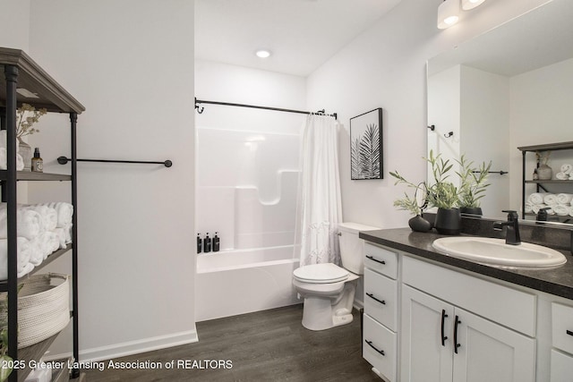 bathroom featuring shower / bath combo with shower curtain, vanity, toilet, and wood finished floors