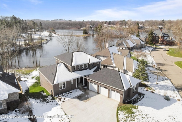 drone / aerial view featuring a water view and a residential view