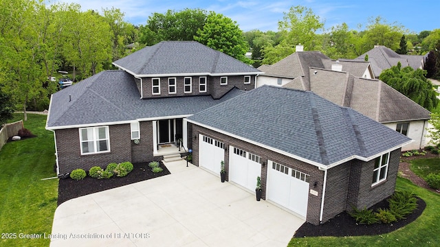 4125 Harbour Cv, Lansing, MI 48911 - view of front facade featuring a garage, a shingled roof, driveway, a front yard, and brick siding