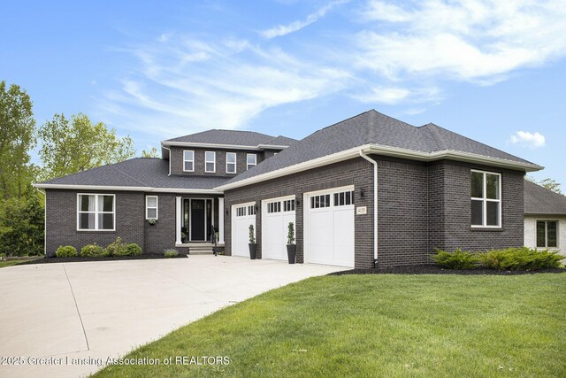 4125 Harbour Cv, Lansing, MI 48911 - view of front of property featuring concrete driveway, a garage, a front yard, brick siding, and a shingled roof