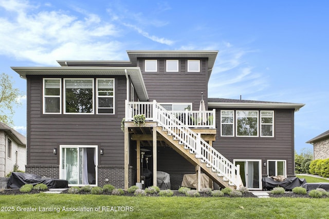 4125 Harbour Cv, Lansing, MI 48911 - back of property featuring stairway, a deck, and brick siding