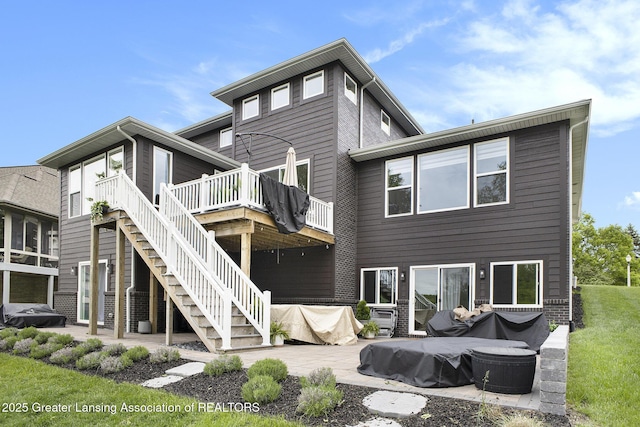 4125 Harbour Cv, Lansing, MI 48911 - rear view of house featuring a deck, stairs, and a patio area