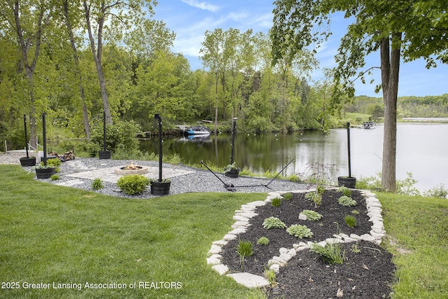 4125 Harbour Cv, Lansing, MI 48911 - dock area with an outdoor fire pit, a lawn, a water view, and a wooded view