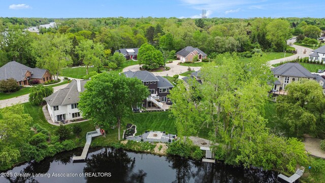 4125 Harbour Cv, Lansing, MI 48911 - aerial overview of property's location featuring nearby suburban area, a large body of water, and a forest