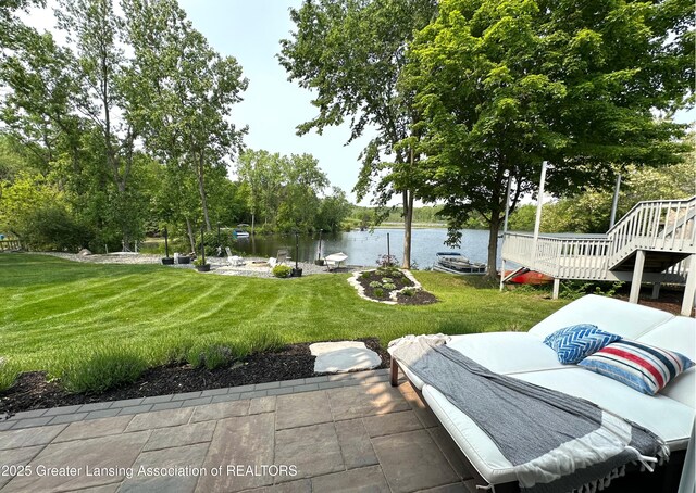 4125 Harbour Cv, Lansing, MI 48911 - view of green lawn with a patio area, stairway, a deck with water view, and view of wooded area