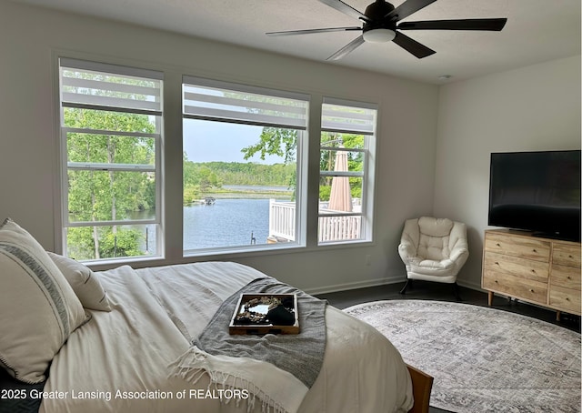 4125 Harbour Cv, Lansing, MI 48911 - bedroom with multiple windows, baseboards, a ceiling fan, and wood finished floors