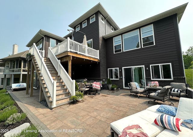 4125 Harbour Cv, Lansing, MI 48911 - rear view of property with an outdoor living space, stairway, a wooden deck, a patio area, and brick siding