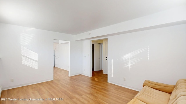 unfurnished living room featuring light wood-style floors and baseboards