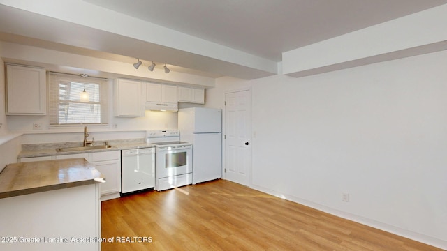 kitchen with white cabinetry, a sink, light wood-type flooring, white appliances, and under cabinet range hood