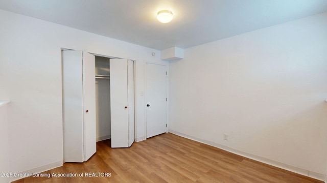 unfurnished bedroom featuring light wood-style floors