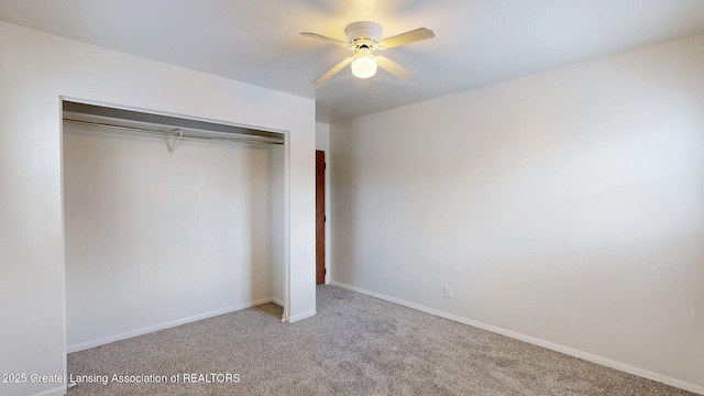 unfurnished bedroom with a ceiling fan, a closet, light colored carpet, and baseboards