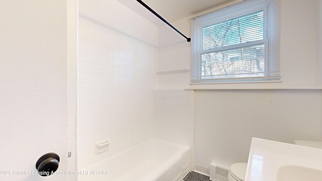 full bath with shower / washtub combination, toilet, and baseboards