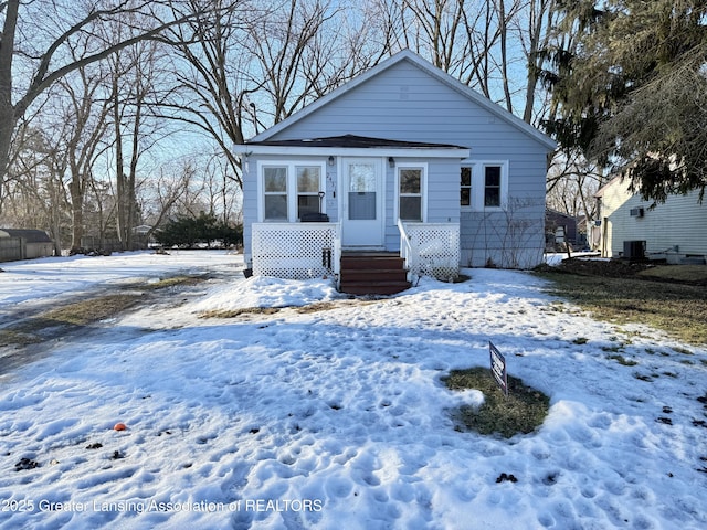 bungalow featuring a porch and central AC unit