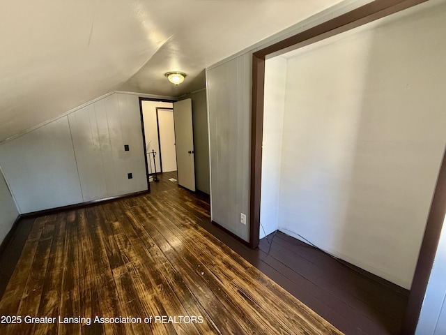 additional living space with lofted ceiling and dark wood-style floors