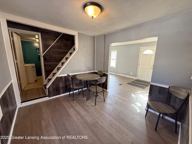 entryway with stairway, baseboards, and wood finished floors