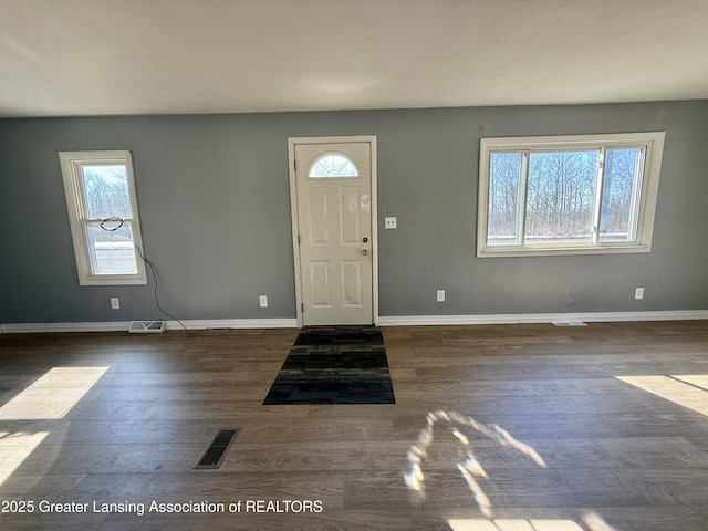 foyer with visible vents, baseboards, and wood finished floors