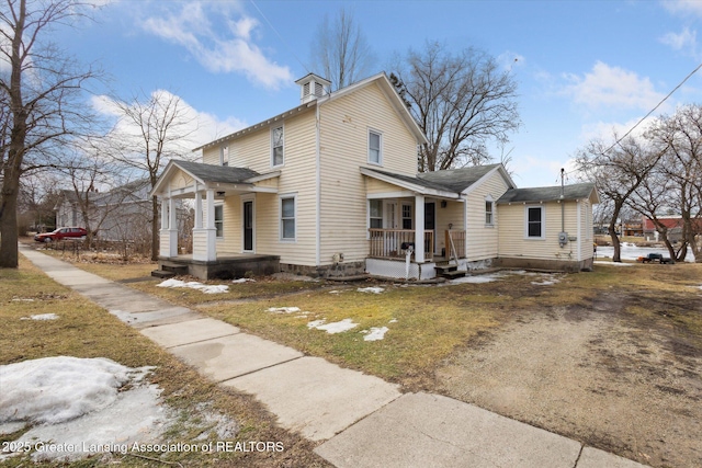 exterior space with a porch and a front yard