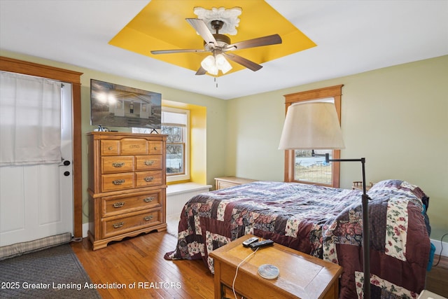 bedroom with a ceiling fan and wood finished floors