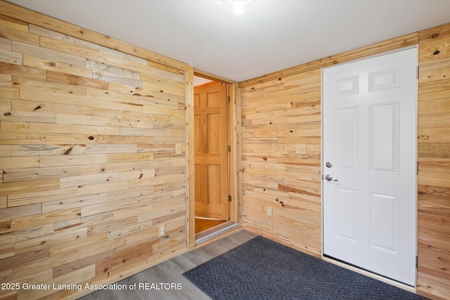 entryway with wooden walls and wood finished floors