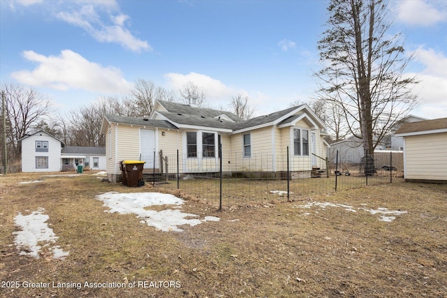 rear view of house featuring fence