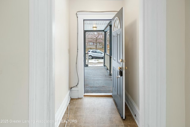 hall with tile patterned flooring and baseboards