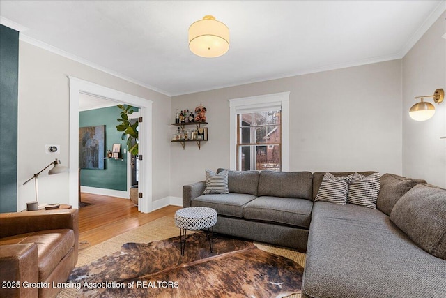 living room with ornamental molding, wood finished floors, and baseboards