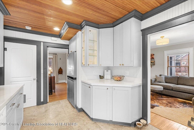 kitchen featuring recessed lighting, light countertops, glass insert cabinets, white cabinetry, and wooden ceiling