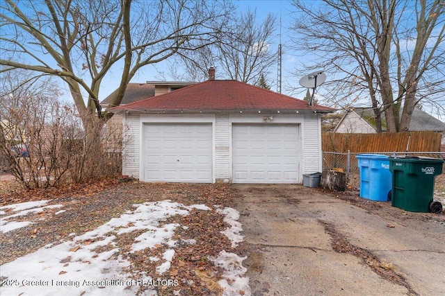 detached garage featuring fence