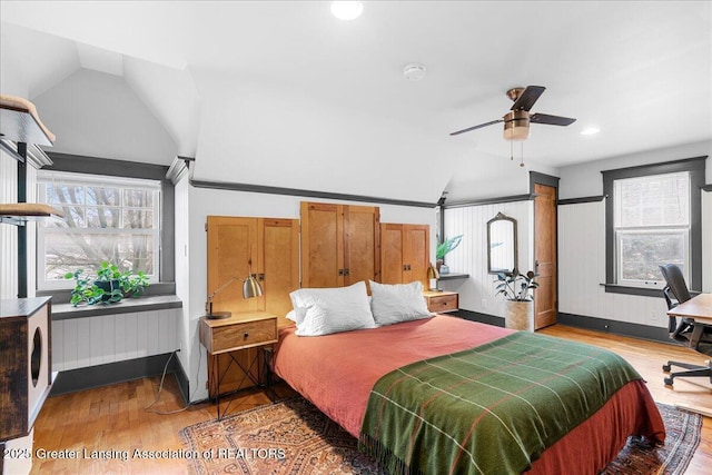 bedroom featuring light wood-type flooring, lofted ceiling, and radiator heating unit