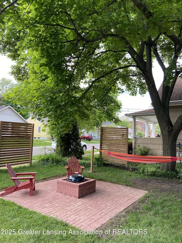 exterior space featuring an outdoor fire pit and a patio area