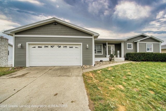 ranch-style home featuring a garage, driveway, and a front lawn