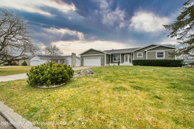 single story home with concrete driveway, a front lawn, and an attached garage