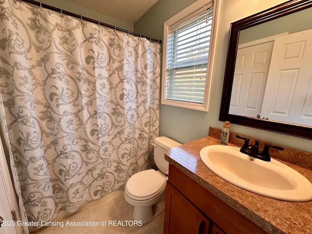 full bathroom featuring a shower with shower curtain, vanity, toilet, and tile patterned floors