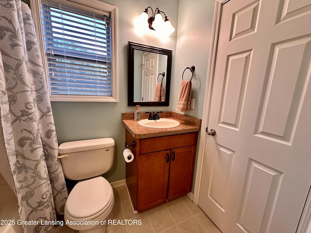 full bathroom featuring tile patterned flooring, baseboards, vanity, and toilet