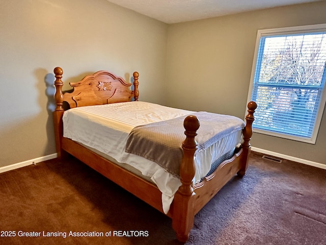 carpeted bedroom featuring visible vents and baseboards