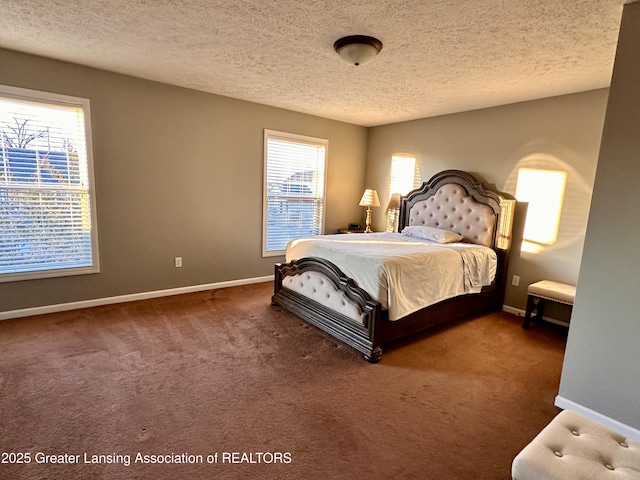 carpeted bedroom featuring a textured ceiling and baseboards