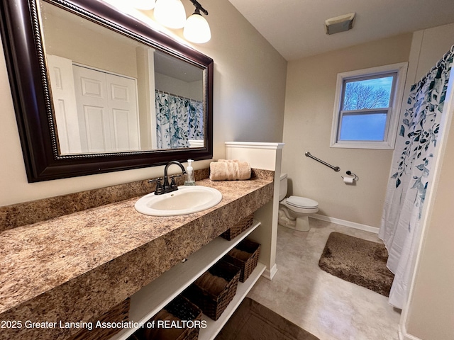 bathroom with baseboards, visible vents, vanity, and toilet