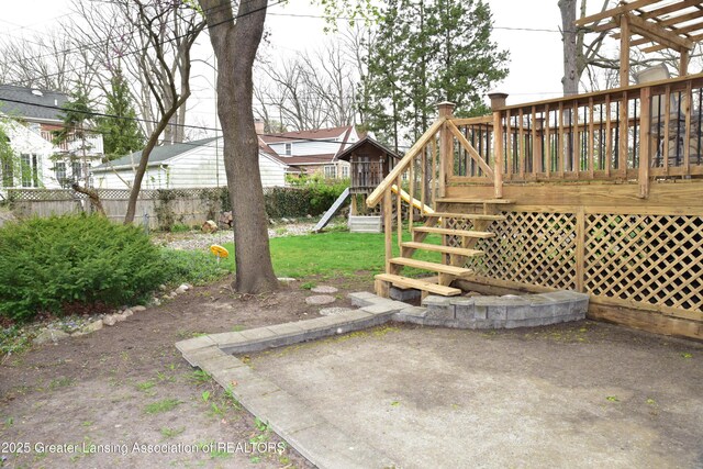 603 N Harrison Rd, East Lansing, MI 48823 - view of yard with stairway, a deck, and fence