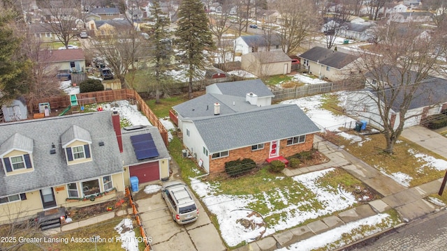 snowy aerial view with a residential view