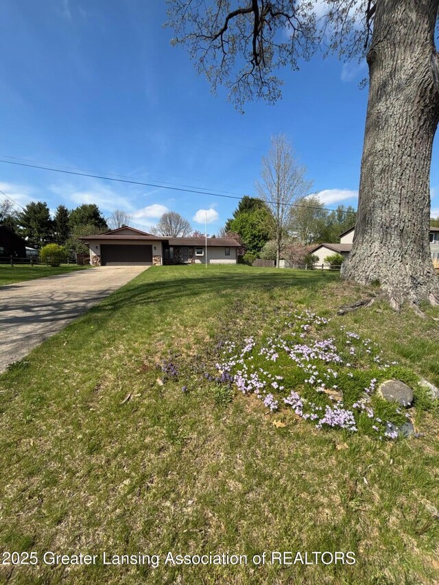 16495 F Dr N, Marshall, MI 49068 - view of yard with an attached garage and aphalt driveway