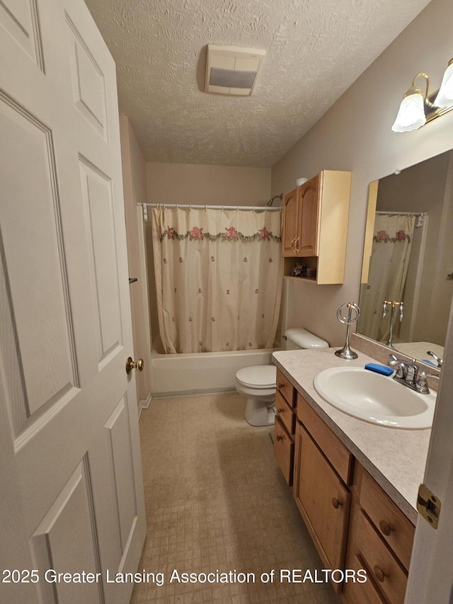 full bathroom with shower / bath combo, vanity, toilet, and a textured ceiling