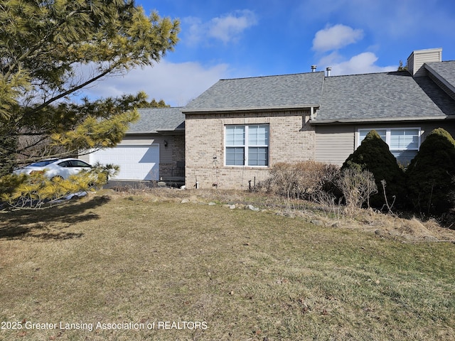 view of front of house with a front lawn, an attached garage, brick siding, and a shingled roof