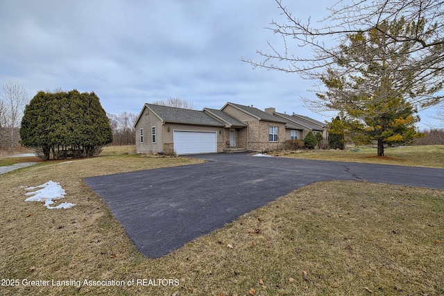 view of front of home featuring an attached garage, stone siding, aphalt driveway, and a front yard