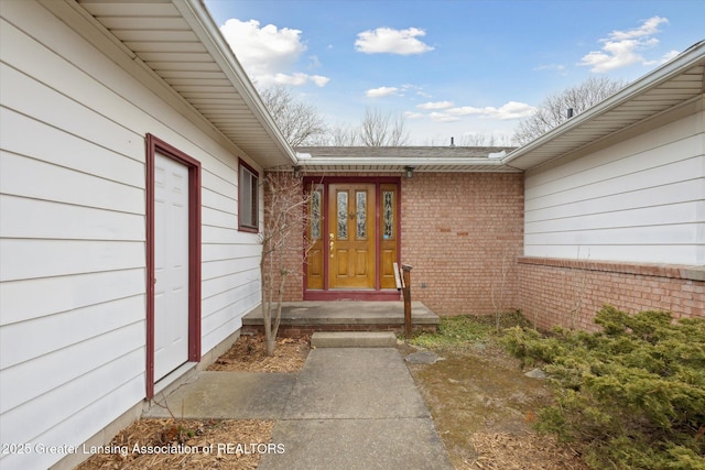 property entrance featuring brick siding