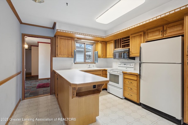 kitchen featuring light floors, light countertops, backsplash, white appliances, and a peninsula